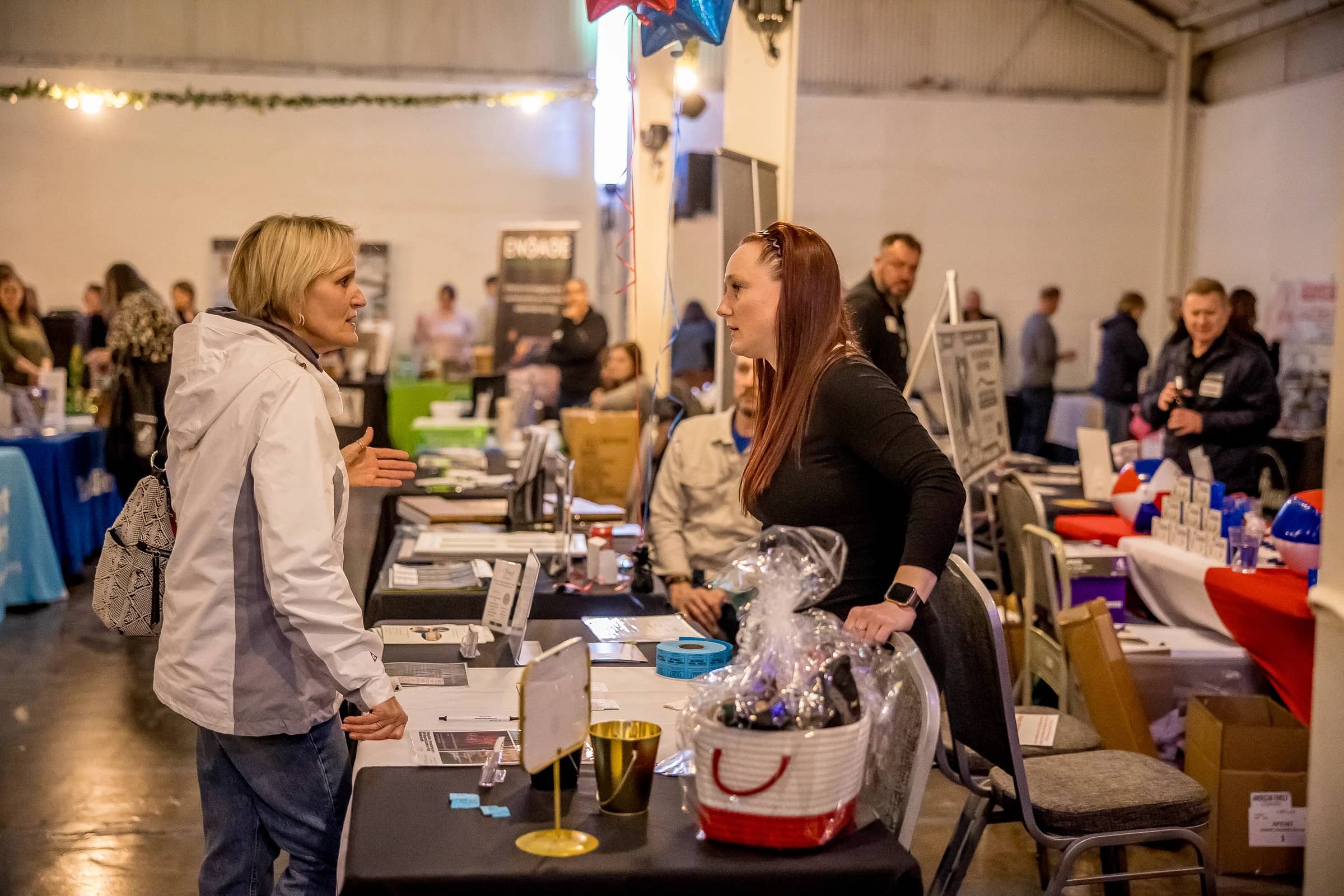 Guests browsing exhibitor tables on the Business Circuit Expo floor